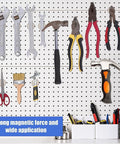 Pegboard wall with assorted hand tools (wrenches, pliers, hammer, scissors, paintbrush) and a small storage tray.