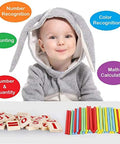 Child in bunny outfit with Counting Number Blocks And Wooden Sticks Kit For Kids Learning Kid Friendly Fun And Easy Way To Boost Math Skills.
