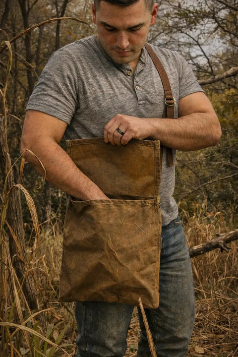 Man with Waxed Canvas Haversack With Adjustable Strap for Outdoor Adventures 11 by 14 Inches in rustic setting.
