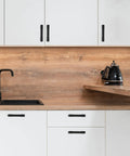 Two Pack 3.75 Inch Matte Black Cabinet Pulls for Kitchen Cabinets and Dressers 96mm Hole Centers on white cupboard doors