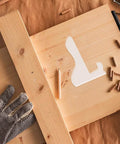 Top view of DIYers Friendly Acrylic Cutting Board And Charcuterie Board Stand Templates With Router Guides And Tracing Stencils For Woodworking placed on wood surface with tools