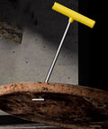 Heavy Duty Stainless Steel Manhole Cover Lifter And Septic Tank Grabber With A Tough T Shaped Handle That Makes Extracting Stubborn Drain Grates And Trampoline Springs A Complete No Sweat Job At 26 Inches on a rusted manhole.