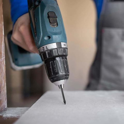 Cordless drill with a 6mm vacuum-brazed diamond tile drill bit drilling into a tile surface.