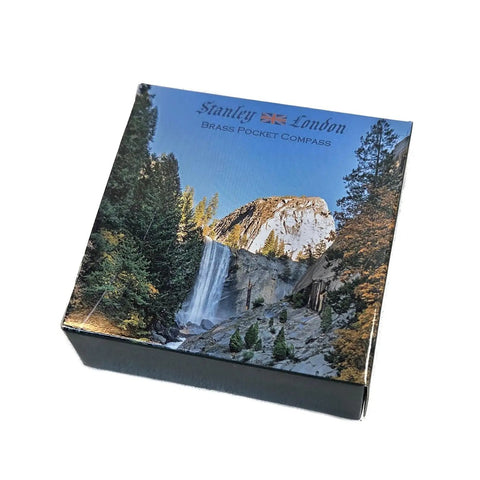 Packaging of Glow In The Dark Brass Pocket Compass For Kids, Waterproof Navigation Tool with outdoor scenic design