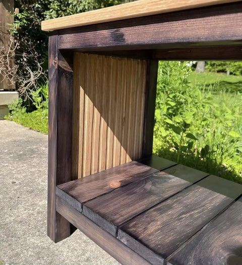 Close-up of a table showcasing Straight Up Charred Aging Wood Stain for Interior Projects on the dark wood. 5 gallon usage.