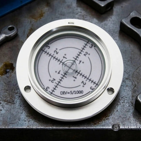 KiBcsLic Metal Circular Bubble Level | 80mm, Flange-Mounted Spirit Level, Precision, with measurement display on metal surface.
