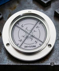 ＡＷＨＡＯ 80mm Round Spirit Level Gauge with Metal Housing and Clear, measuring surface angles on a metal surface.