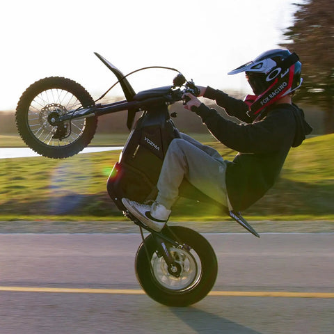 IN10 Electric Dirt Bike With 2600W Peak Motor, 40 MPH Top Speed, 48V 23Ah Battery, Full Hydraulic Brakes And Suspension, Off Road Mountain Ebike For Teens And Adults, Ready To Rip Trails, rider doing a wheelie on paved road
