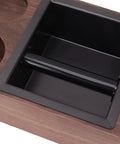 Close-up of the stainless steel knock box in the Legit Premium Walnut Wood Coffee Tamping Station with adjustable height.