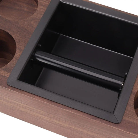 Close-up of the stainless steel knock box in the Legit Premium Walnut Wood Coffee Tamping Station with adjustable height.