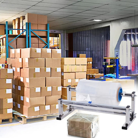 Warehouse with stacked boxes and Stainless Steel Tabletop Stretch Film Dispenser With Film Slide Cutter in foreground.