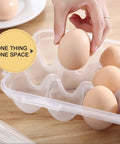 Hand placing an egg into a Two Pack Covered Egg Holders For Fridge Clear Plastic Deviled Egg Tray Carrier With Lids Holds 36 Eggs