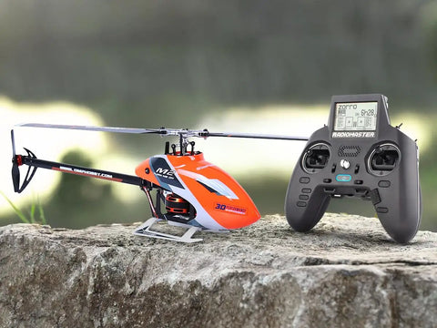 Ready To Fly Pro Grade RC Helicopter With Dual Brushless Motors Direct Drive 6CH Remote resting on a rock outdoors