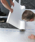 Peel and Seal Self Stick Roll Roofing Aluminum 36 Inch Wide Durable Self Adhesive Roofing Material For Quick Patches And Long Lasting Leak Protection Exterior Grade being applied by two workers on a roof.