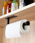 Under-cabinet paper towel holder with self adhesive mount, matte black finish, in kitchen, holding paper towel roll