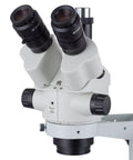 45X Simul-Focal Stereo Zoom Microscope With Trinocular Port For Crystal Clear Dual Eyepiece Viewing And Imaging, Dope Lab Gear For Research, Education, And Microbiology Projects. White stereo microscope head with dual eyepieces and zoom controls.