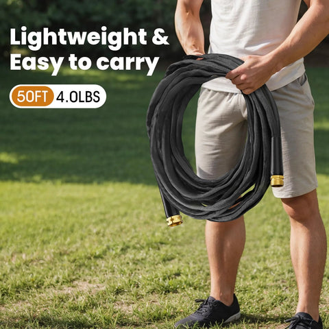 Haeteir 50ft garden hose, black with brass fittings, coiled and held outdoors