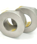 Two metal bushings from Heavy Duty Front Wheel Bearing Replacement Kit With Four Bushings Two 121748X Two 121749X Thrust Washers And Clips