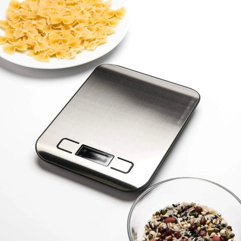 Digital Kitchen Scale With 11 Lb Capacity, Grams And Ounces, Stainless Steel Platform, Backlit Display, Tare Function next to pasta dish