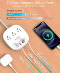 Ultra Thin 10 Foot Flat Plug Power Strip With 3 Outlets And 4 USB Ports Including 2 USB C next to charging smartphone on desk