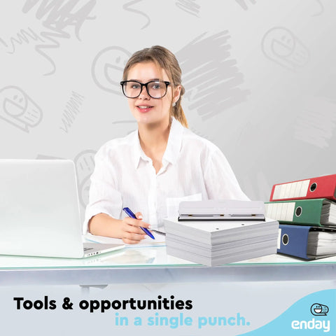 Person at desk with Heavy Duty 3 Hole Punch For Binders, laptop, and binders in office setting.