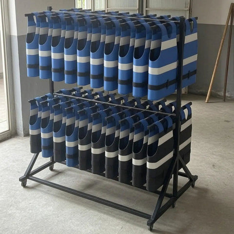 Rock Solid Commercial Life Vest Display Rack On Smooth Brake Wheels For Poolside Deck Marine Rescue Gear Storage Organizer With Top Shelf Steel Frame, holding blue and black vests.