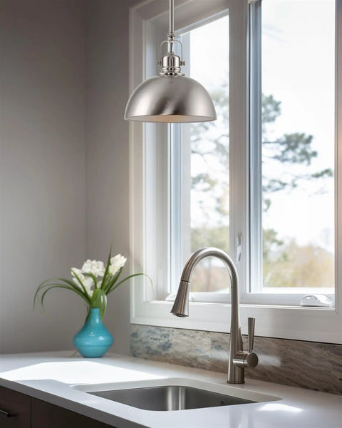 Kira Home Belle 9" Modern Industrial Pendant Light with Dome Shade, Petit Retro Metal Silver Hanging Light, Brushed Nickel Finish over kitchen sink.