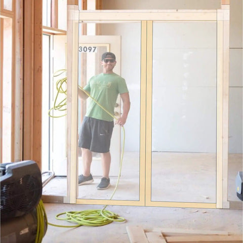 Man installing Magnetic Dust Barrier Door Kit Pro Grade For Construction Containment Self Closing Easy To Install Reusable Shield.