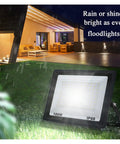 JUDYSSY Led Flood Light 100W IP66 Waterproof outdoor spotlight illuminating garden area at night.
