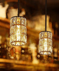 Twin black finish crystal pendant lights over bar area with warm glow, resembling vintage farmhouse crystal pendant light black finish