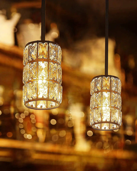 Twin black finish crystal pendant lights over bar area with warm glow, resembling vintage farmhouse crystal pendant light black finish