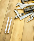 White Plastic Drawer Slides Full Extension Kit beside tools on wooden surface for cabinets and furniture installation