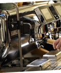 Close-up of espresso machine with steam wand insulation cover for espresso machine heat sleeve replacement kit in use.