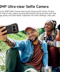 Kickass 5G Rugged Champ With Built-In Thermal Scanner And Sharp Night Vision Lens, Smooth 6.78 Inch FHD Plus Display Packing 24GB RAM And 256GB Vault, Android 14 Unlocked Powerhouse With Hefty 10600mAh Juice And Quick Wireless Charging during a selfie with group outdoors.