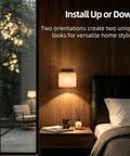 AuroraSpher Indoor Hardwired Modern Milky White Acrylic Black Wall Sconce installed above nightstand in bedroom setting.