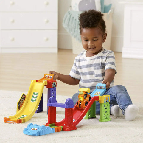 Toddler playing with Go Smart Wheels 3 In 1 Launch Raceway Build Dual Race End To End Super Race And Side By Side Stunt Track