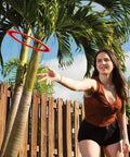 Woman throwing a 10 Inch Sprint Ring Flying Disc for Maximum Distance in backyard, showcasing lightweight outdoor ring thrower.