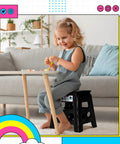 Child sitting on 13 Inch Folding Step Stool 2 Pack No Slip Lightweight Collapsible Stool With Handy Grab Handle Supports Up To 300 Lbs For Kitchen Bathroom Bedroom Garden Indoor Outdoor Black