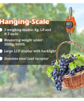 Built Like A Tank Digital Crane Scale With A Slick Backlit Lcd Screen And Solid Stainless Hook For Tracking Big Game Livestock Weigh Ins And Daily Job Site Hauls with grapes in basket.