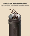 Fino Portable Electric Coffee Grinder With 28 Grind Settings For Espresso To French Press, shown with coffee beans being loaded.