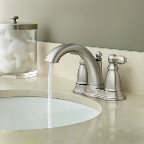 Brantford Brushed Nickel Two Handle Low Arc Traditional Centerset Bathroom Faucet With Drain Assembly in use on a countertop.