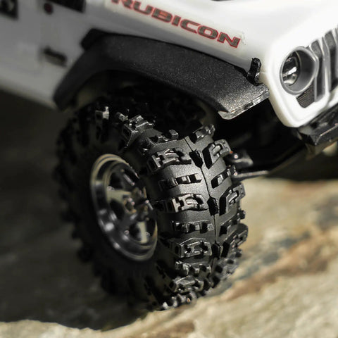 Close-up of 36x14mm 0.7 Inch Swamp Claw RC Tires for 1/30 Axial SCX30 with soft sticky S5 compound on rocky terrain