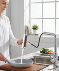 KAIYING Waterfall Kitchen Faucet with Pull Down Sprayer & Glass Rinser in modern kitchen setting, using sprayer on gray pan.