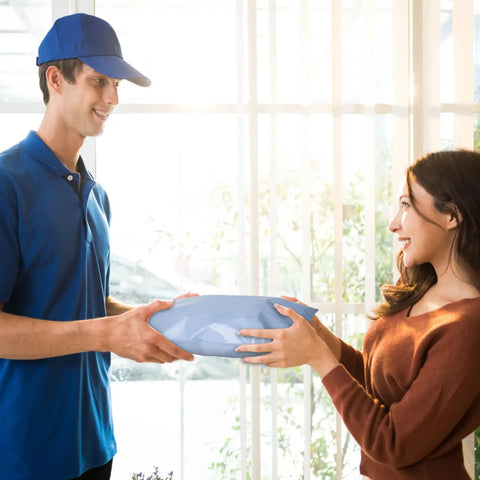 Delivery person handing a package in a Light Blue 6x9 Poly Mailers 120 Pack Self Adhesive Waterproof Tear Proof Shipping Bags With Gray Inner Lining.
