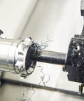 Quarter Inch Shank Lathe Indexable Boring Bar Holder S06KSCLCR06 in use with metal lathe, showing cutting process on steel piece