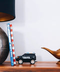 Decorative setup with Aladdin Genie Lamp LED Mood Light 10 Inch Blue And White Mood Lighting Figure on a wooden shelf.