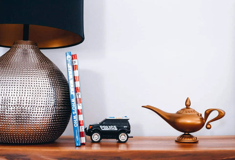 Decorative setup with Aladdin Genie Lamp LED Mood Light 10 Inch Blue And White Mood Lighting Figure on a wooden shelf.