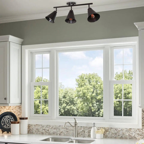 Ellis 27 Inch Industrial 3 Light Track Lighting With Adjustable Heads, oil-rubbed bronze, mounted above kitchen window