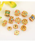 Grab These Dope Hollow Transfer Beads For Your Next DIY Jewelry Build And Stack Up Some Fire Sand Gold Spacer Charms featuring assorted gold spacer beads with colored accents.