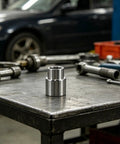 Steel Bottle Jack Lift Extension Adapter 1.38 Inch Height For Car Lifts And Trucks on a workshop table, silver finish